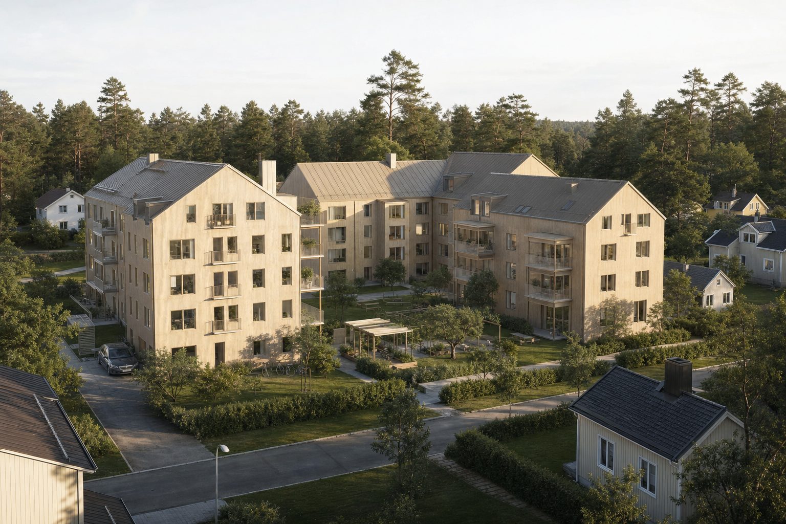 Fyra våningar höga trähus kring en grön innergård i Bällsta, Vallentuna.